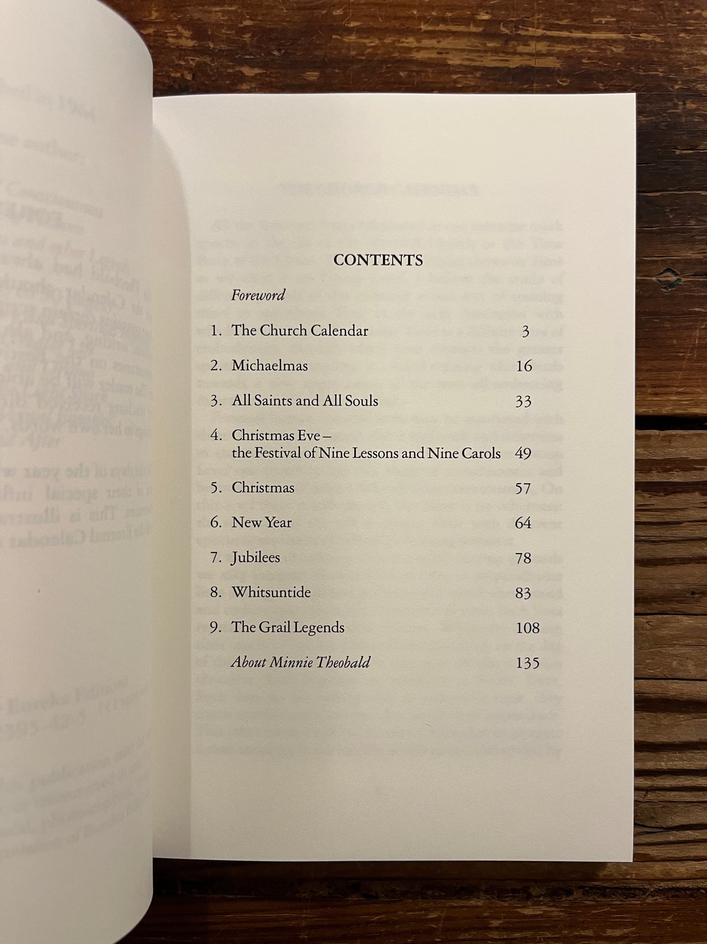 Open book titled 'The Eternal Calendar' by Minnie Theobald with a simple white design on the cover.