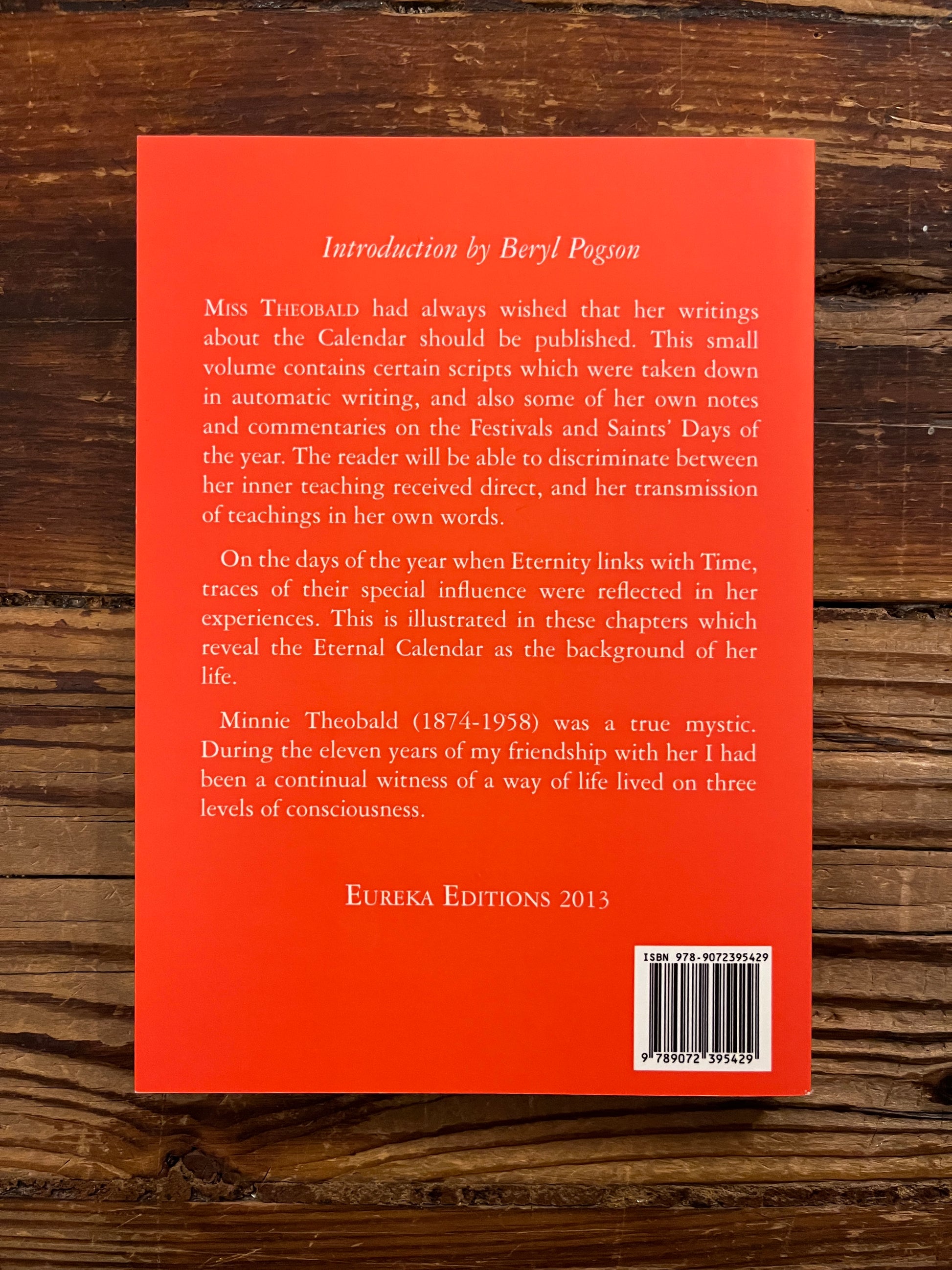 Back cover of book titled 'The Eternal Calendar' by Minnie Theobald with a simple white design on the cover.