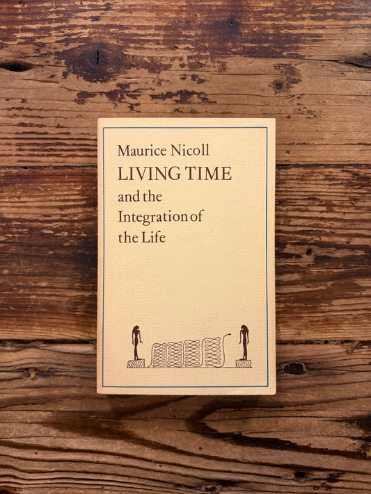Front cover of a book with the title 'Living Time and the Integration of the Life' by Maurice Nicoll, a 1976 Watkins Edition lying on a wooden surface 