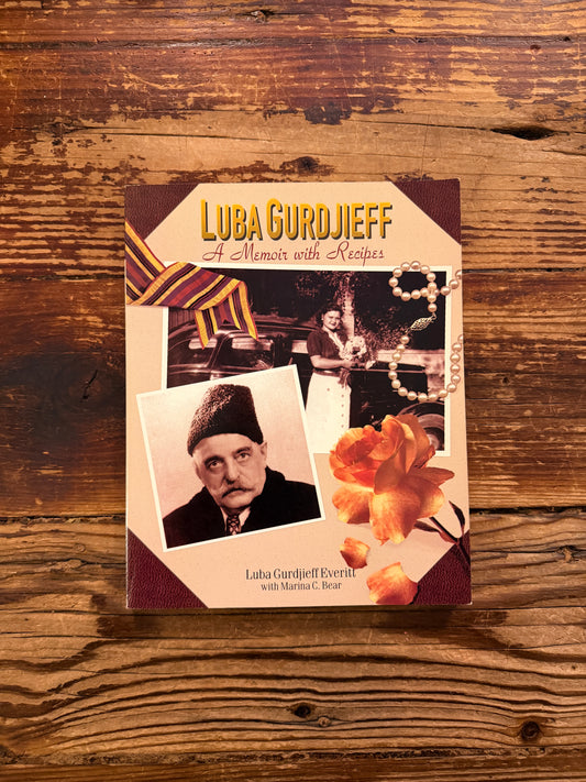 Front cover of a book titled 'Luba Gurdjieff: A Memoir with Recipes' by Luba Gurdjieff Everitt on a wooden surface 