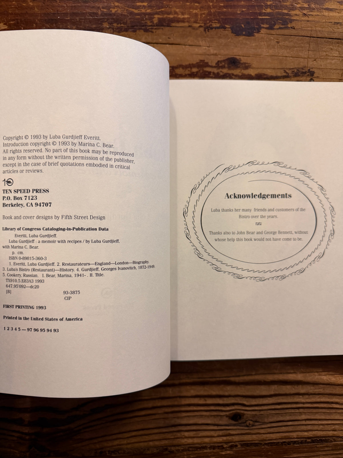 Open book titled 'Luba Gurdjieff: A Memoir with Recipes' by Luba Gurdjieff Everitt on a wooden surface 