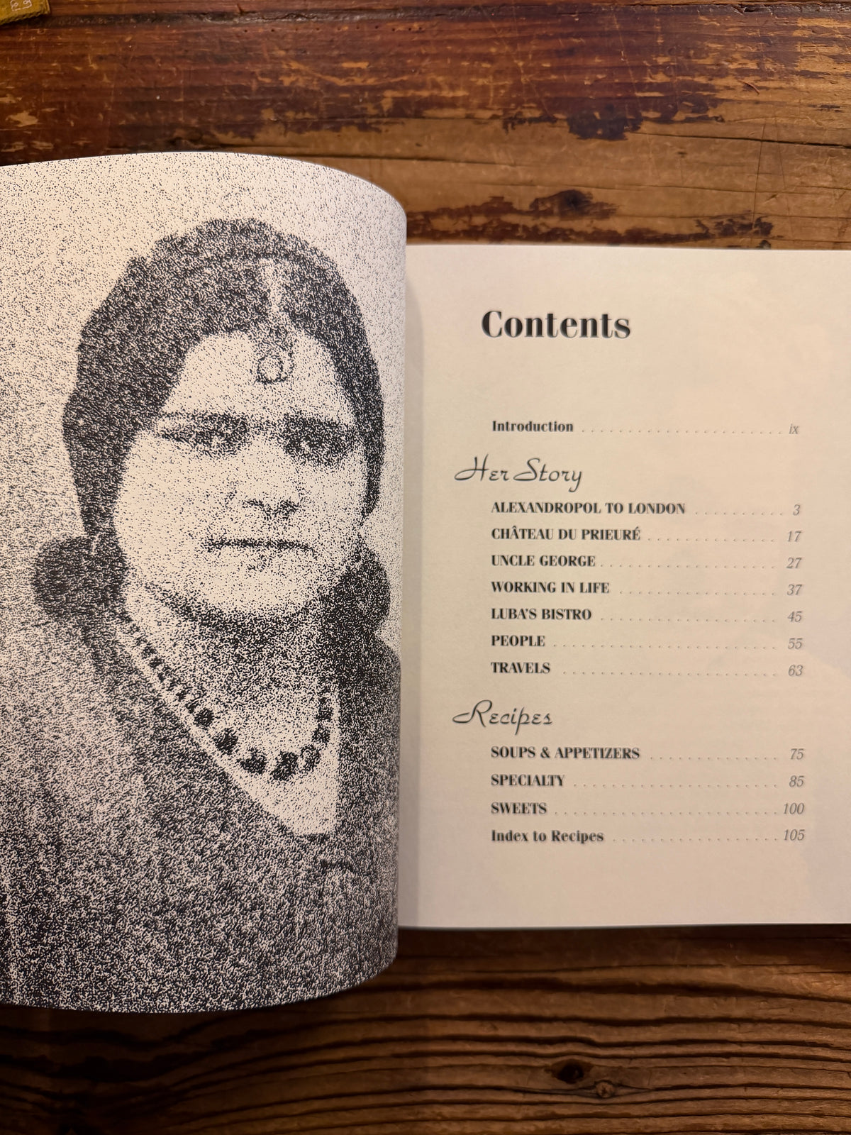 Open book titled 'Luba Gurdjieff: A Memoir with Recipes' by Luba Gurdjieff Everitt on a wooden surface 