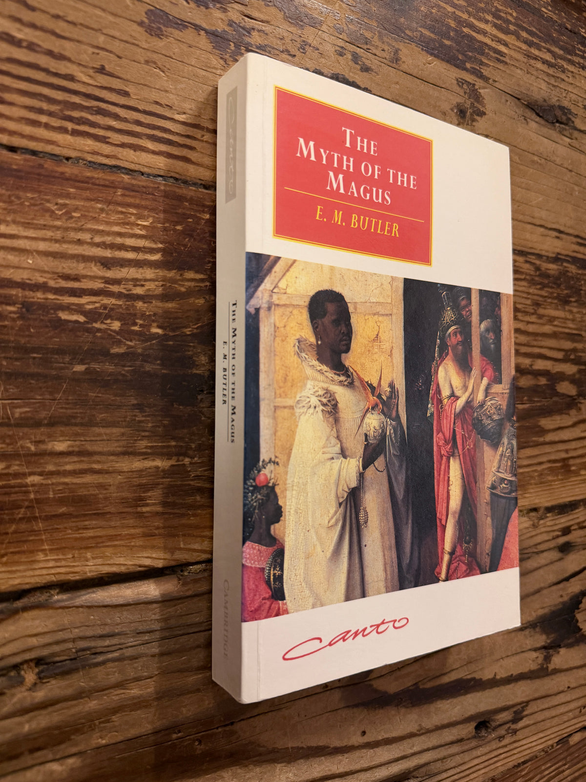 Front cover and spine of a book with the title 'The Myth of the Magnus' by E.M. Butler lying on a wooden surface