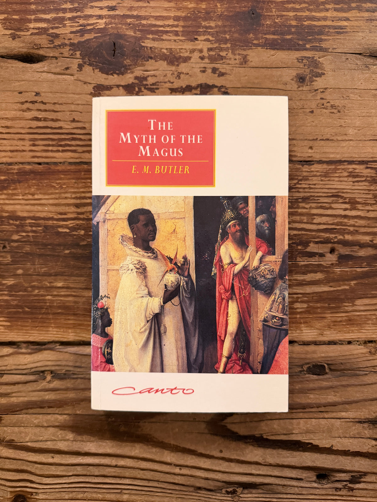 Front cover of a book with the title 'The Myth of the Magnus' by E.M. Butler lying on a wooden surface