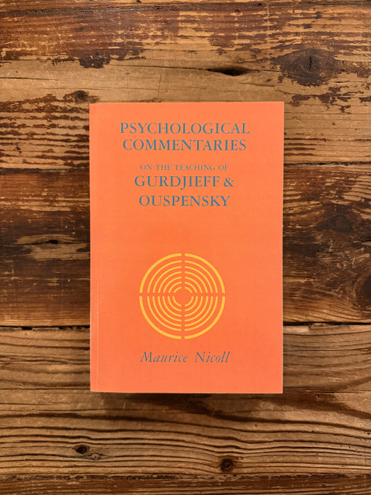 Front cover of a book titled 'Psychological commentaries on the teaching of Gurdjieff & Ouspensky, vol I' by Maurice Nicoll lying on wooden surface