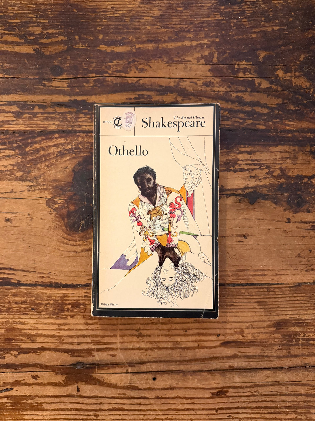 photo of the cover of the book "othello" on a wooden background