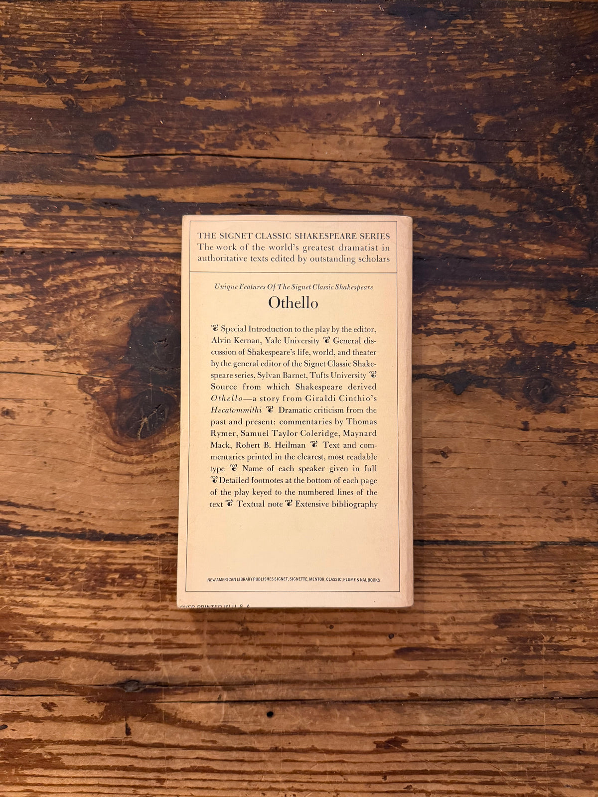 photo of the cover of the book " othello" on a wooden background