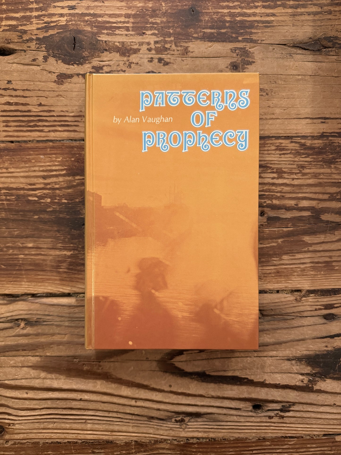 Front cover of a book titled 'Patterns of Prophecy' by Alan Vaughan on a wooden surface