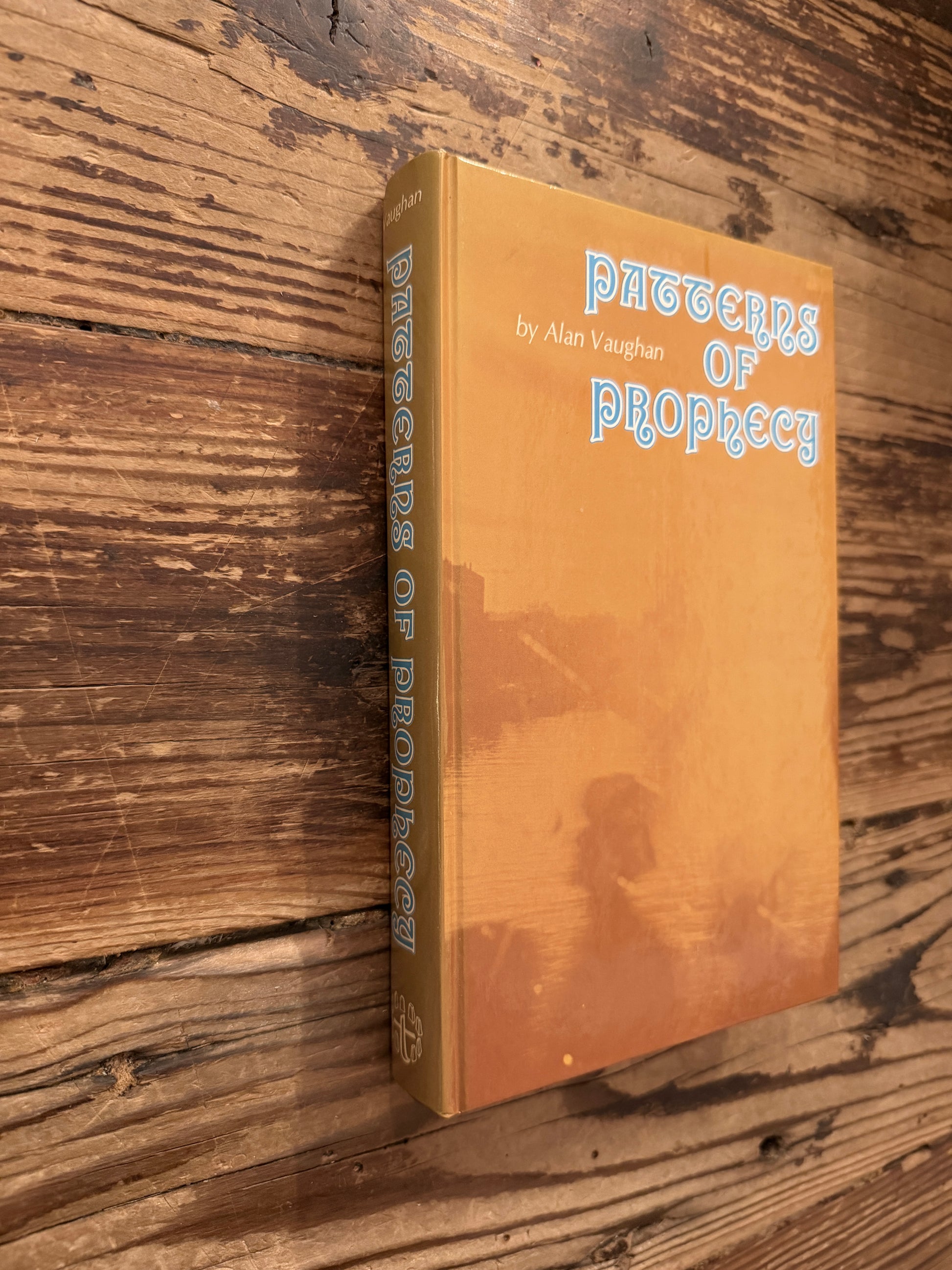 Front cover and spine of a book titled 'Patterns of Prophecy' by Alan Vaughan on a wooden surface
