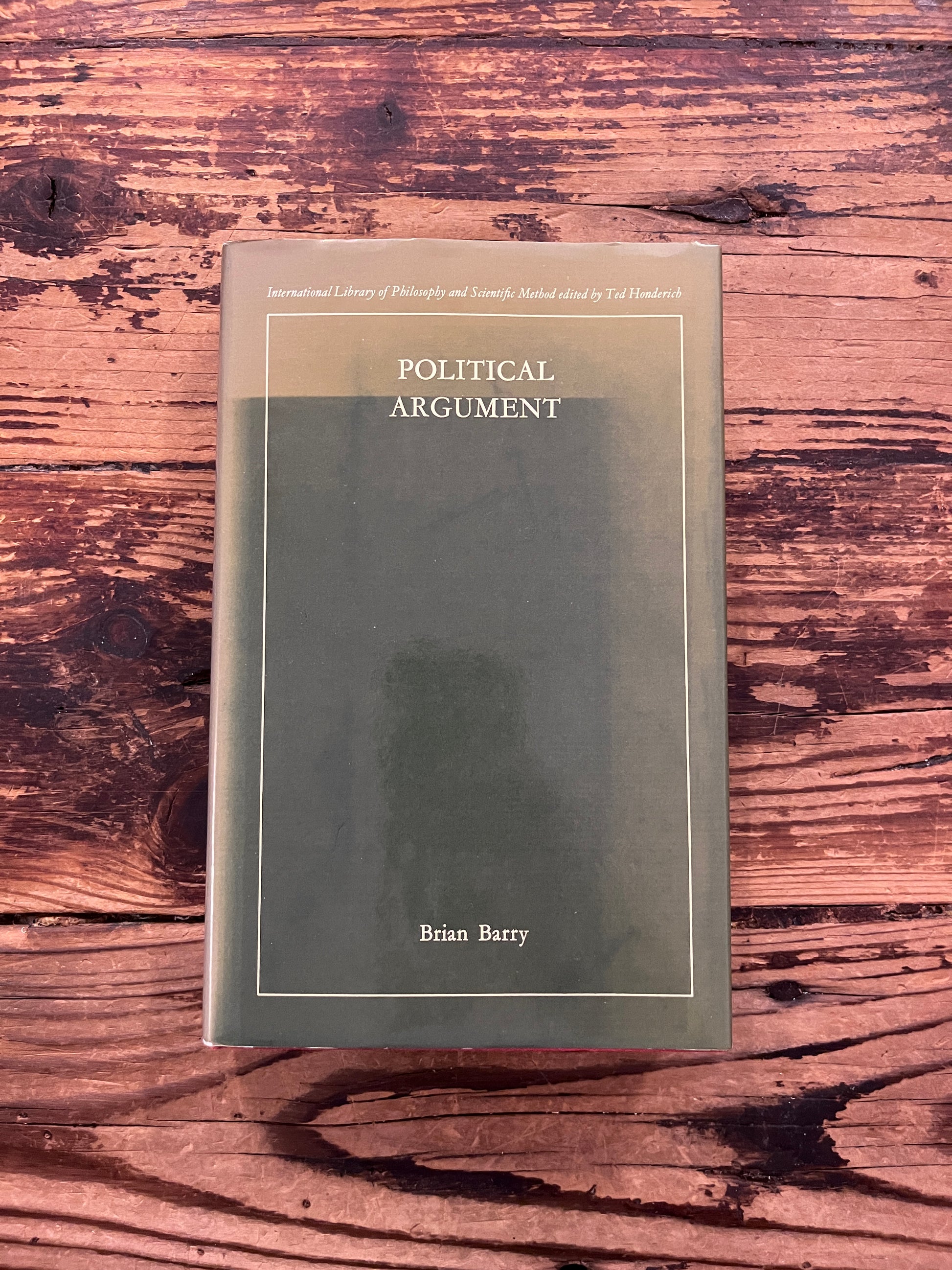 photo of the cover of the book "Political Argument" on a wooden background